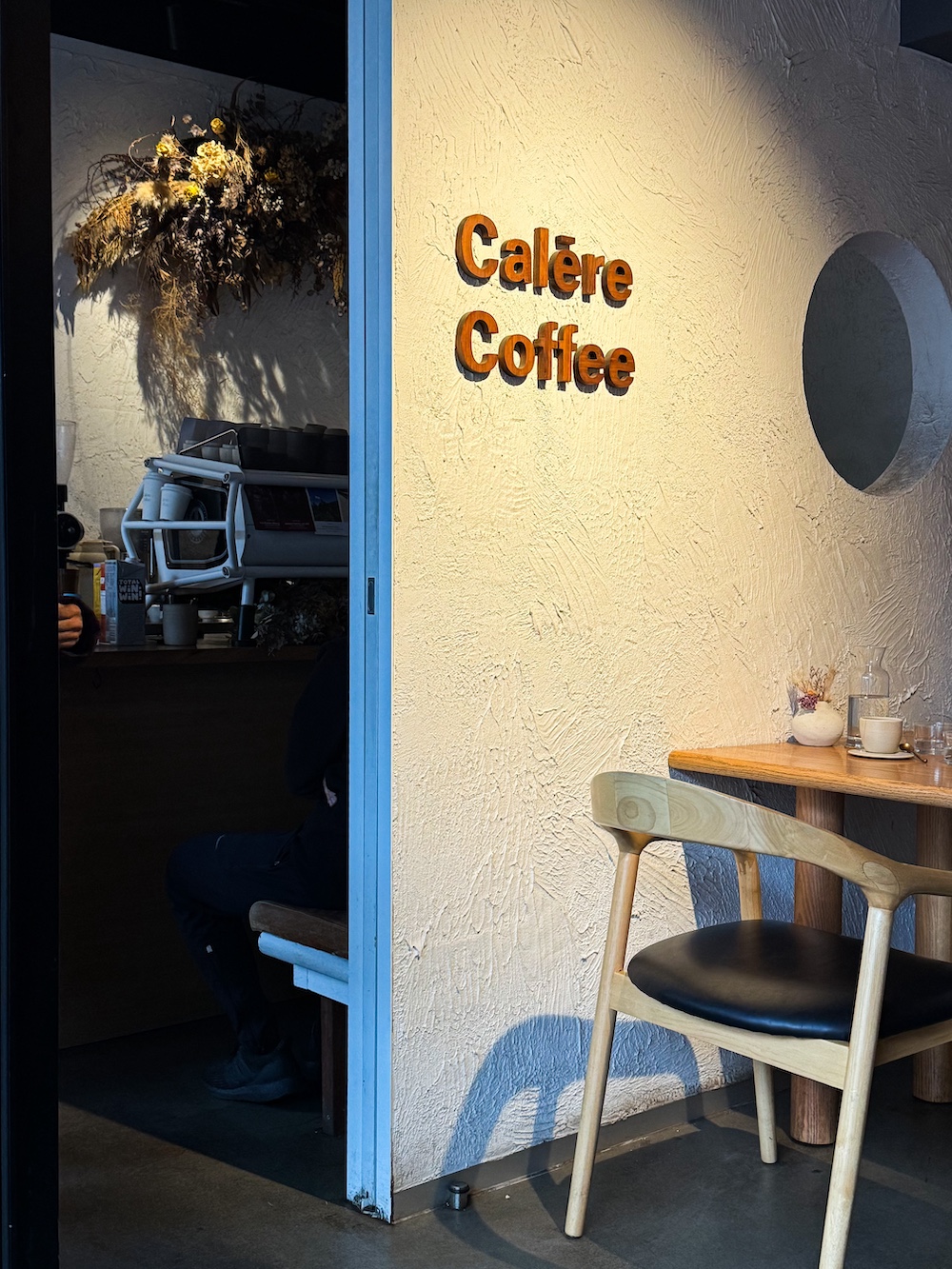 A coffee shop wall with a sign 'Calare Coffee'.