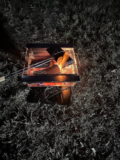 A jaffle iron making dinner on the firepit
